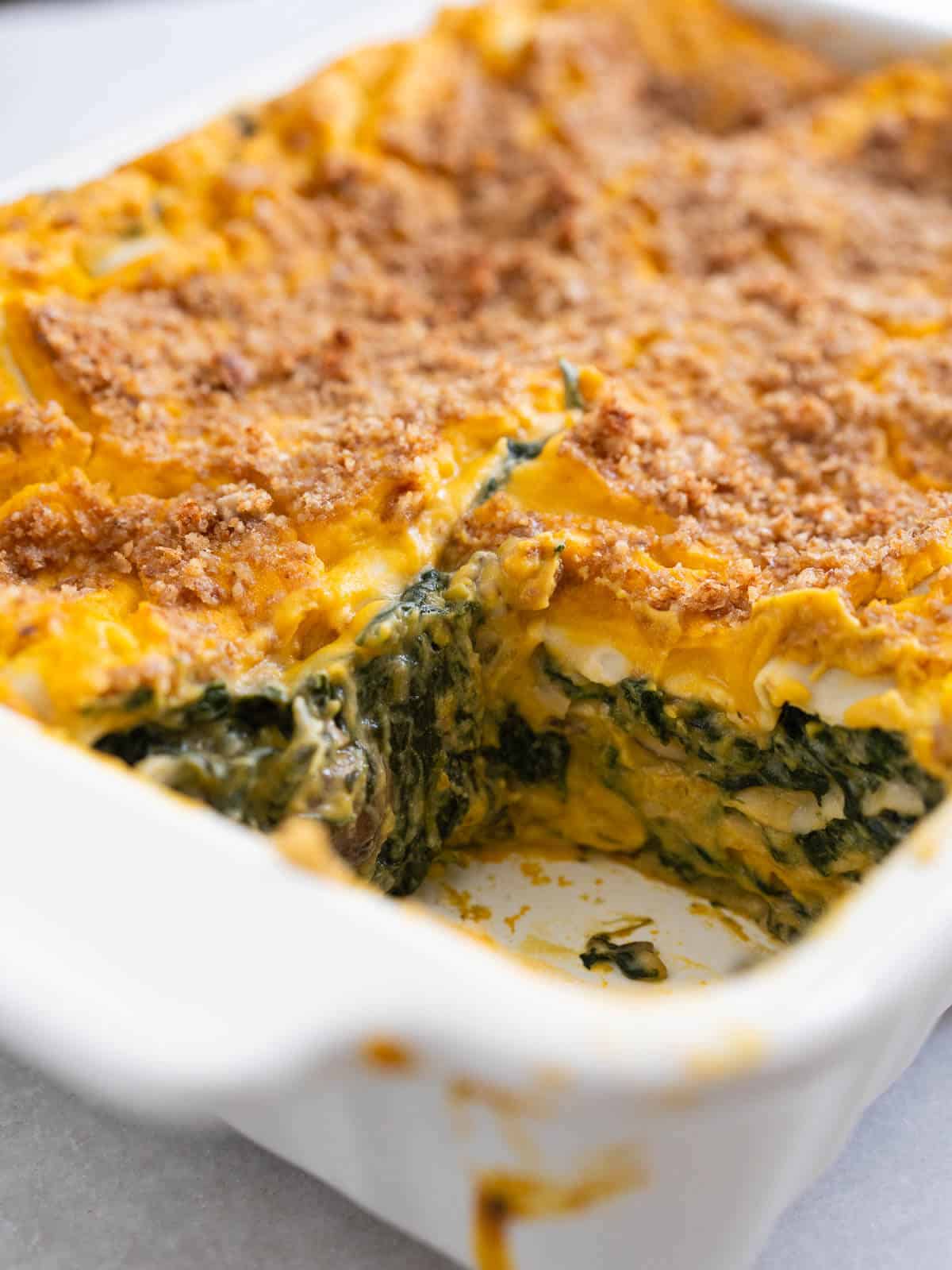 serving butternut squash spinach lasagna.