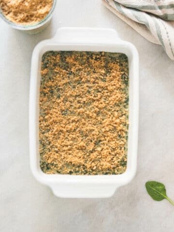add vegan parmesan on top before taking the baking dish to the oven.