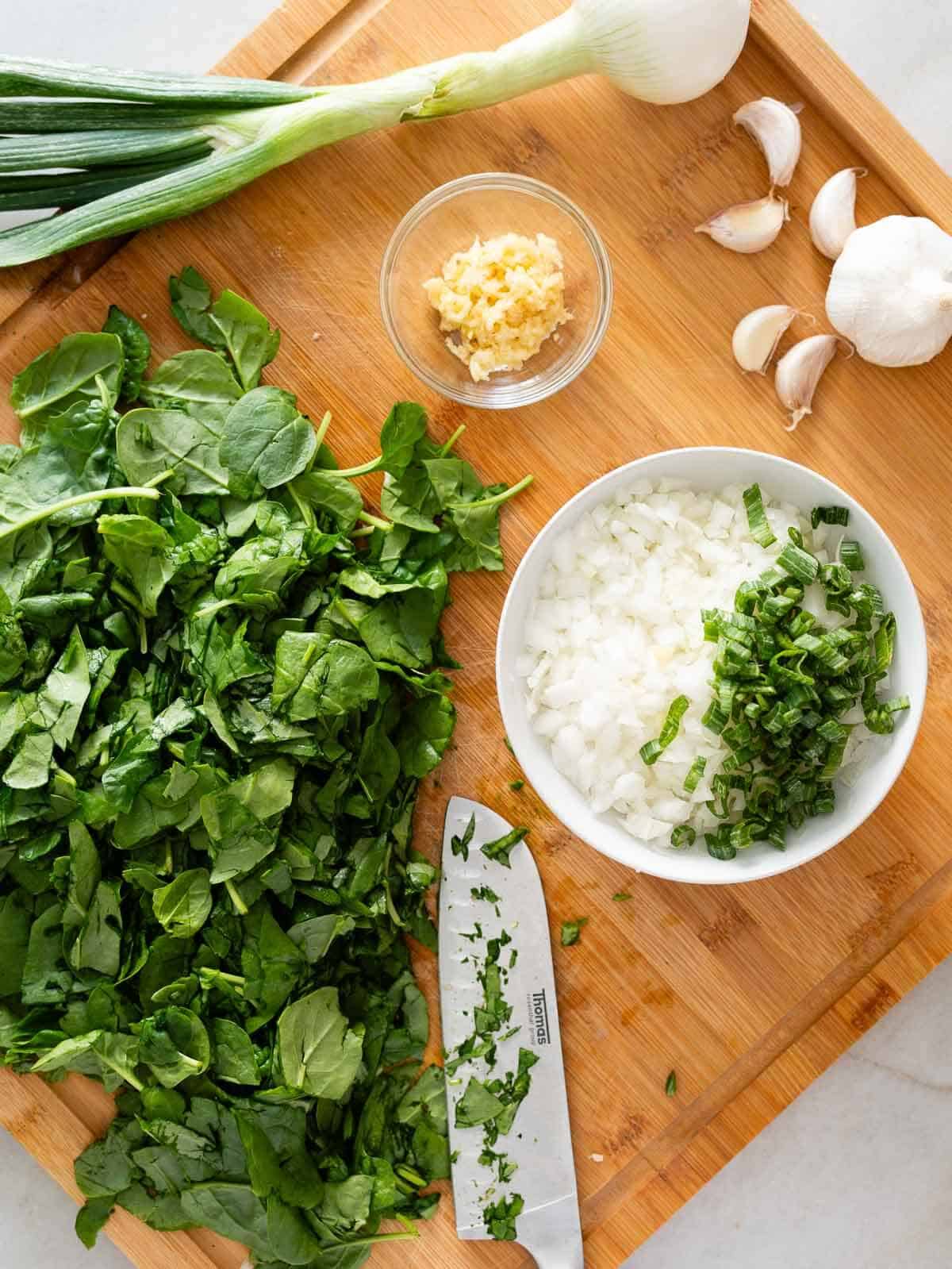 chop the onions, garlic, and spinach.