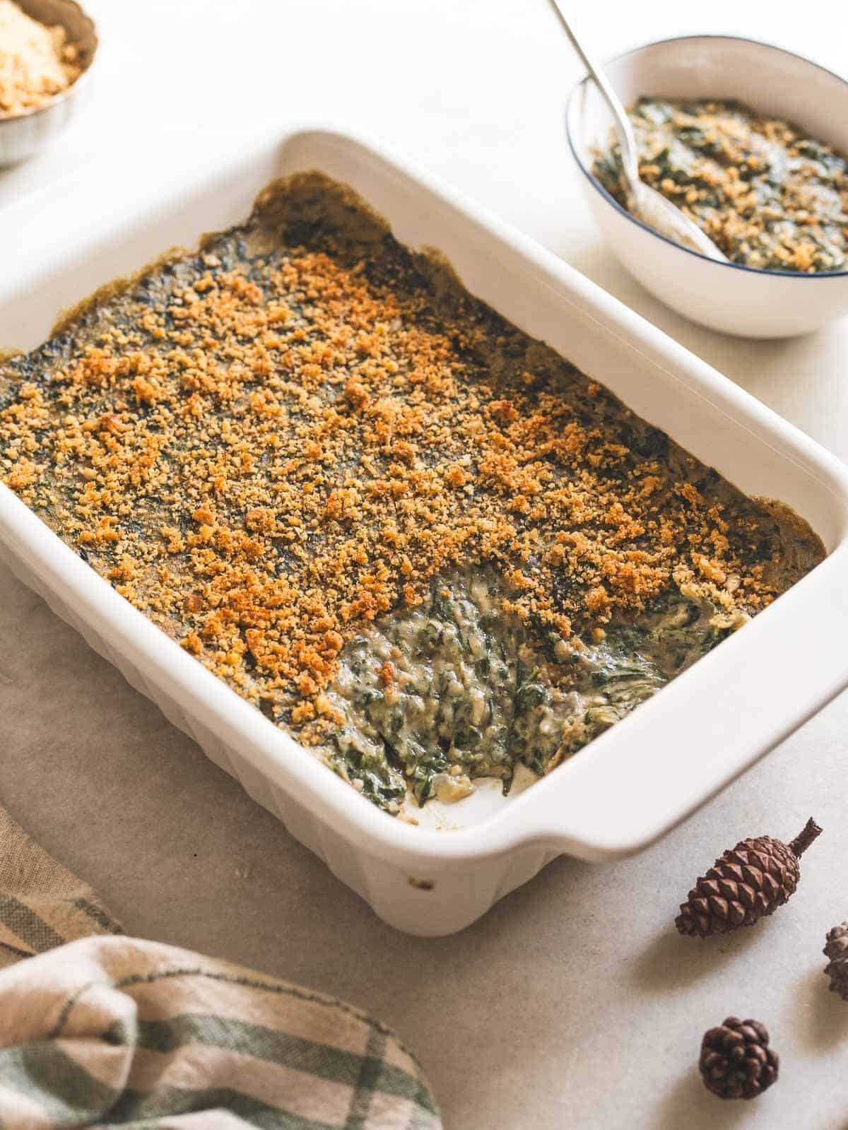 creamed spinach casserole with a taken portion.