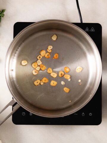 remove toasted garlic flakes from the olive oil and reserve.