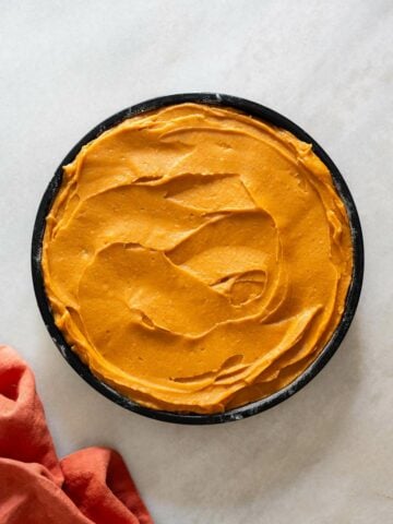 Jamaican sweet potato pudding cake pour batter in baking dish.