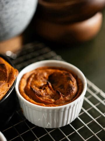 sweet potato pudding ramekins in cooling rack.