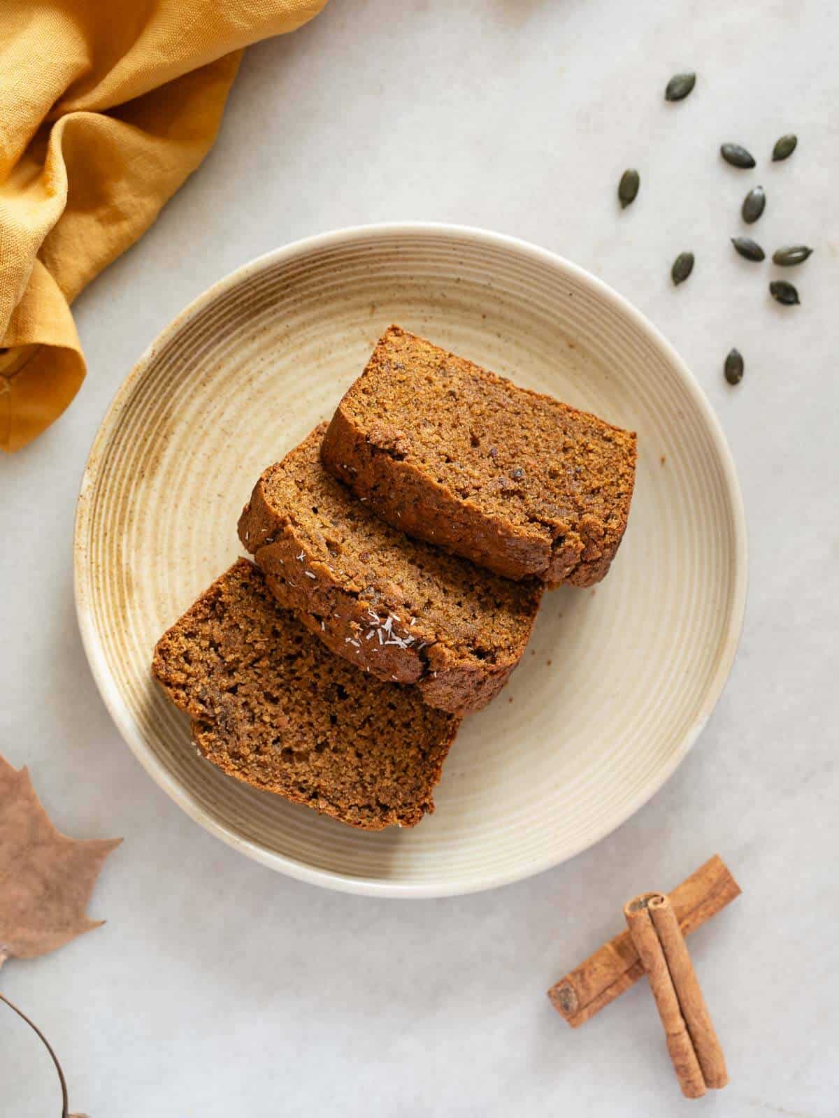 three slices of pumpkin loaf cake on a plate.