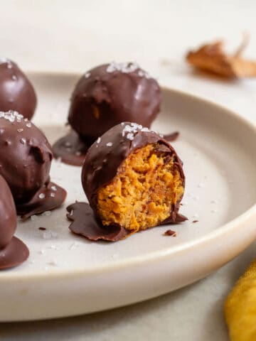 chocolate-covered pumpkin protein balls in a plate.