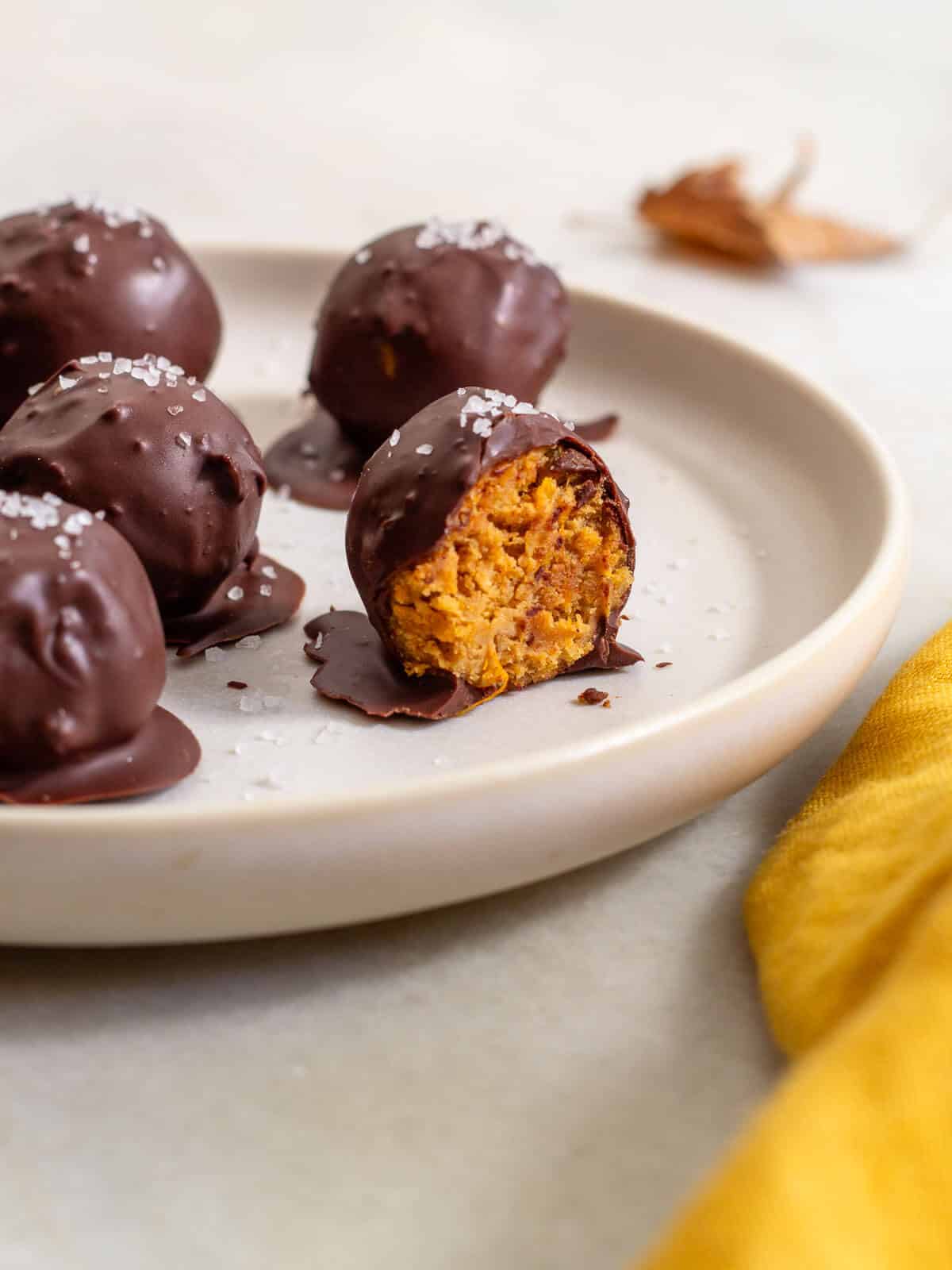 chocolate-covered pumpkin protein balls in a plate.