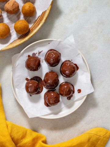 pumpkin protein balls covered in melted chocolate.