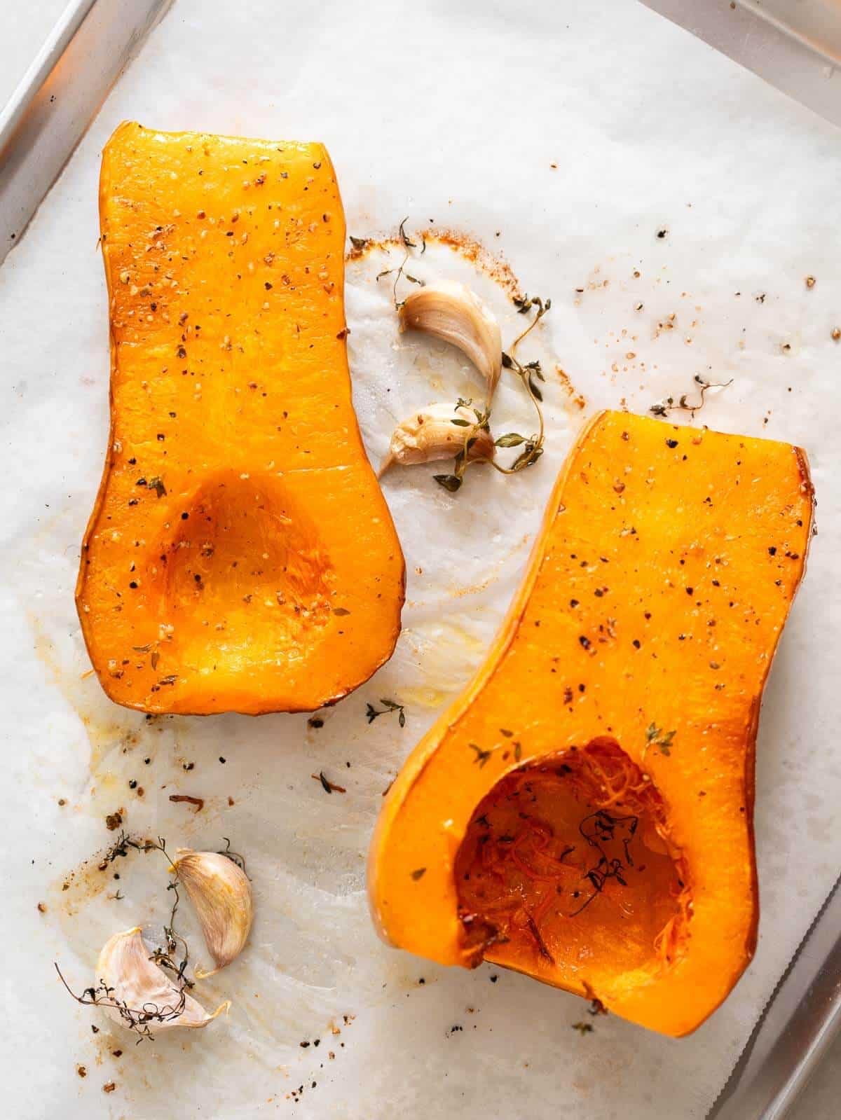 roasted butternut squash laying on a baking dish.