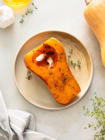 serve the roasted squash on its own in a serving plate with roasted garlic.
