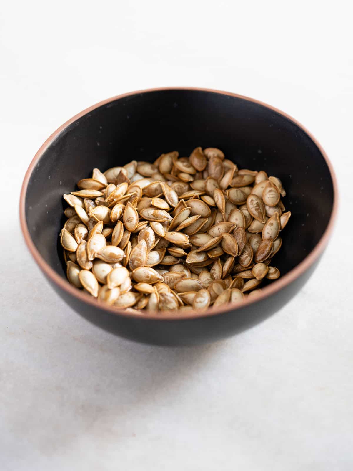 roasted squash seeds in a small bowl.