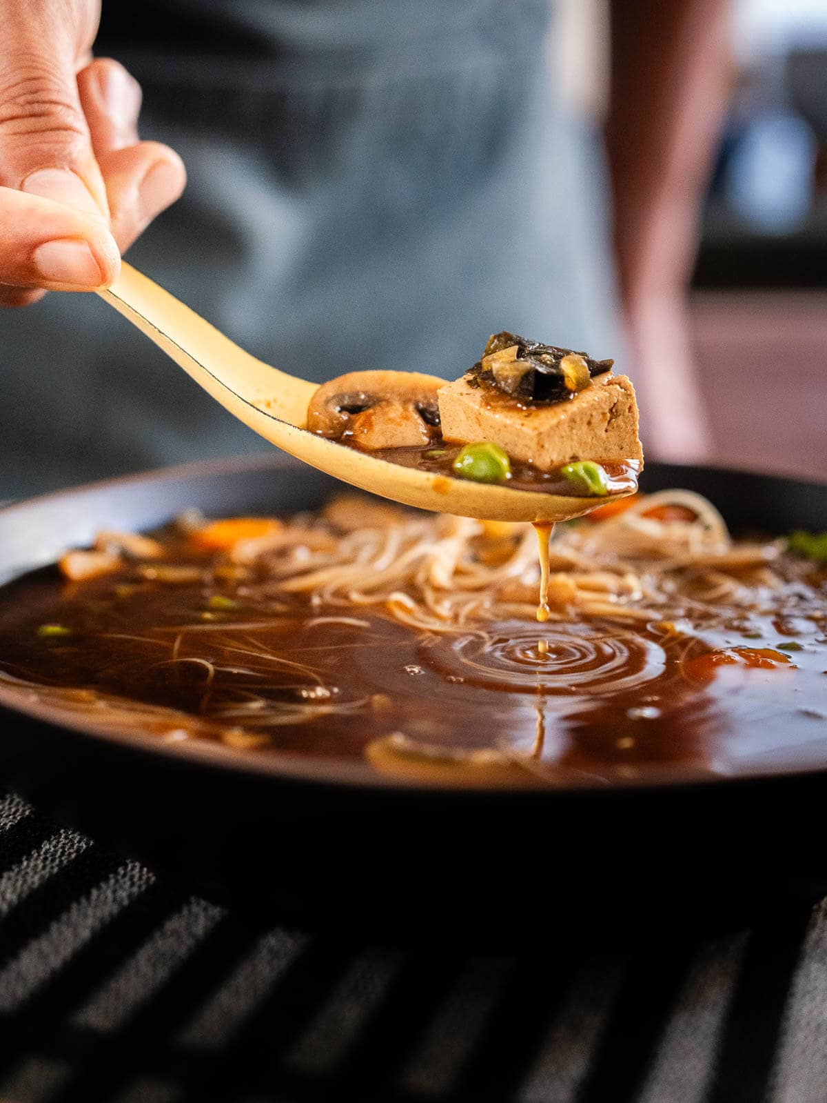 spoonful with miso soup with mushrooms.