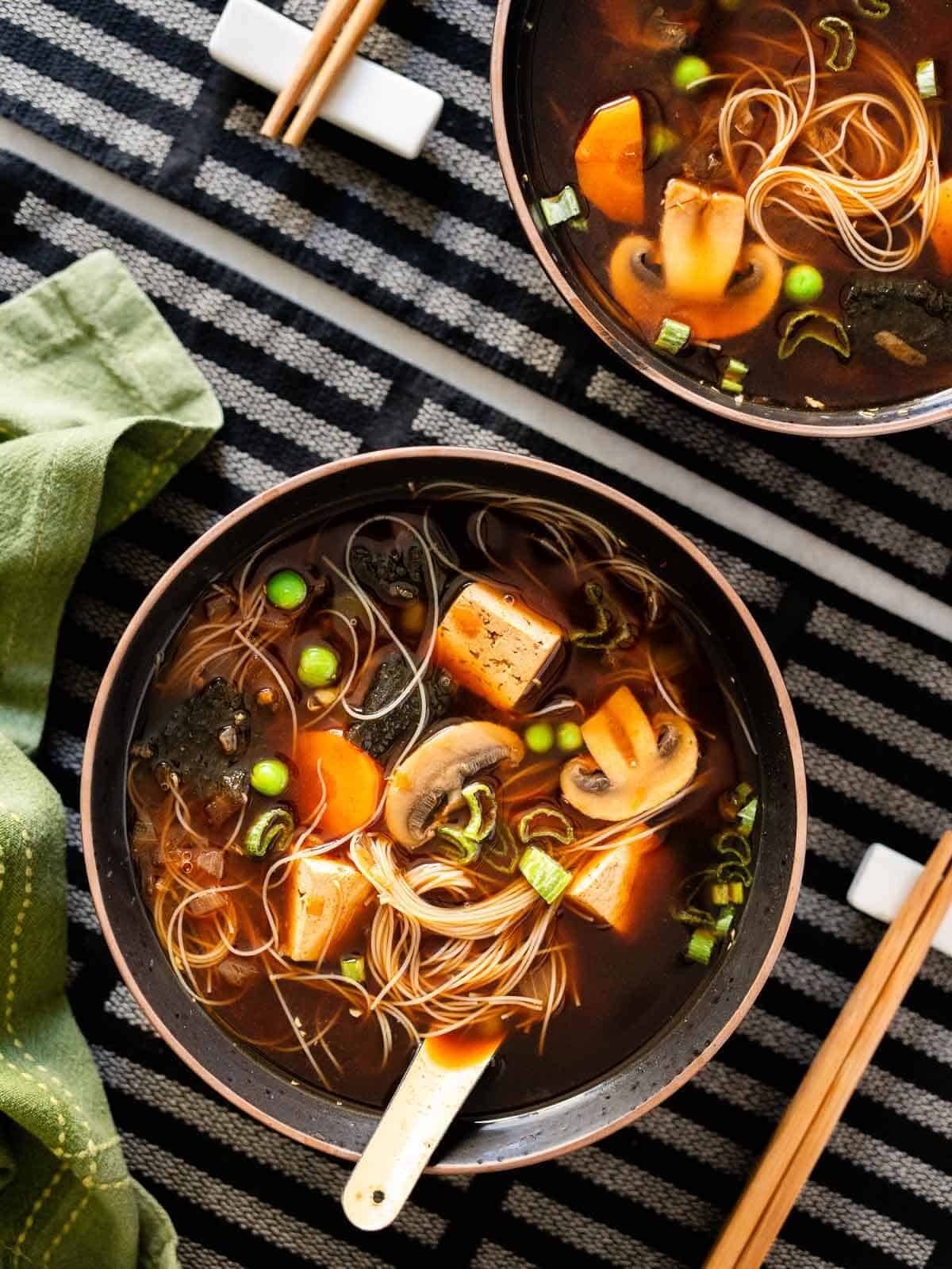 sprinkle garnishes to the vegetable miso soup.