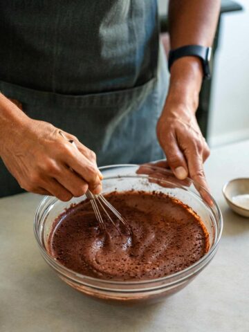 stirring in chocolate powder into the vegan buttermilk, flax meal mixture, using a whisk.