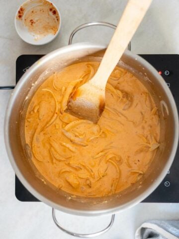 adding coconut milk into the saucepan.