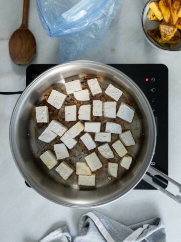 Stir fry the tofu in a skillet with oil.