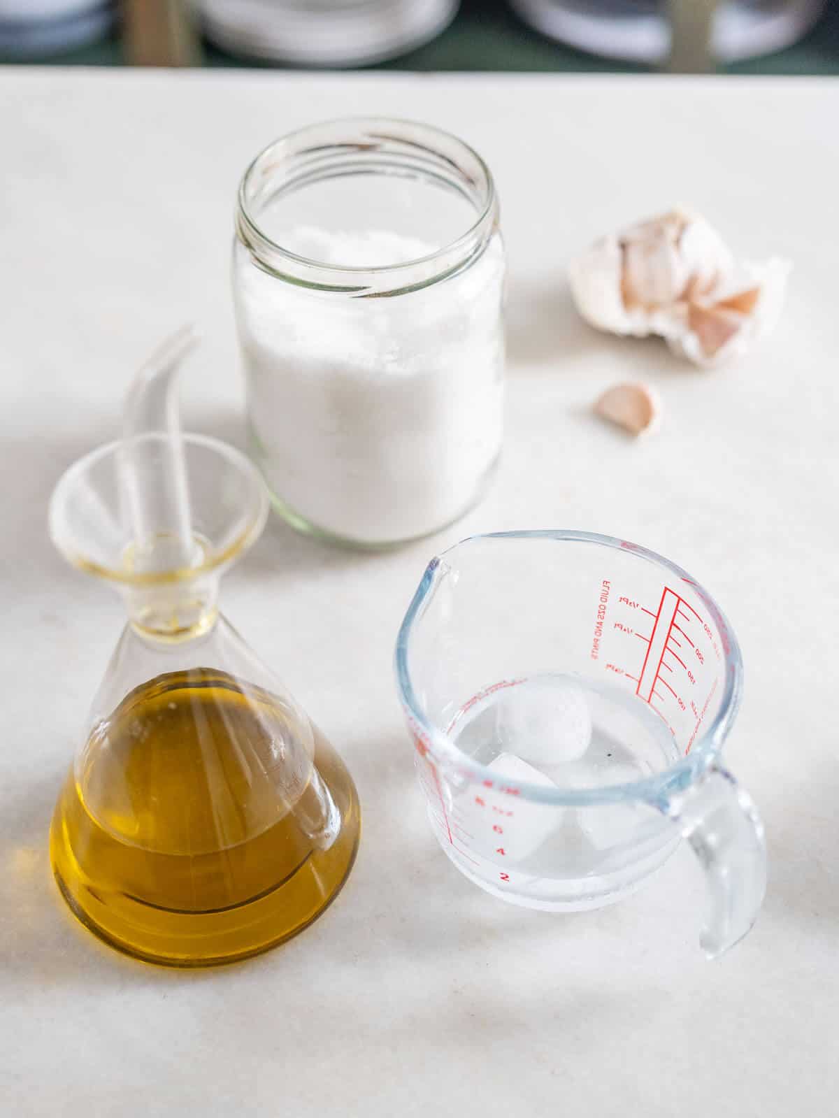 ingredients to adjust the flavor and texture of the hummus: olive oil, iced water, and garlic.