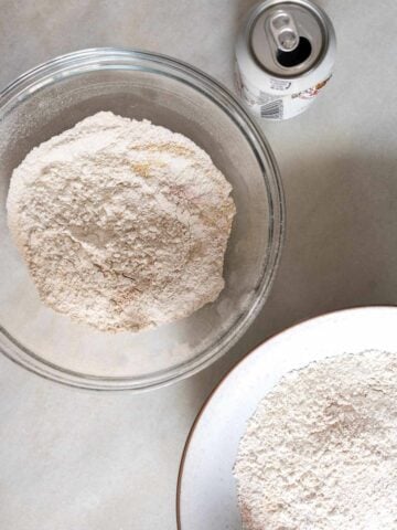 dry ingredients mix, divided into two bowls, with a can of beer to be added two one of the mixtures.