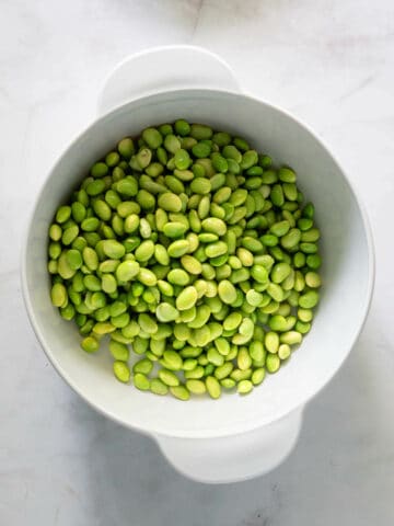 thawed edamame beans in a bowl.