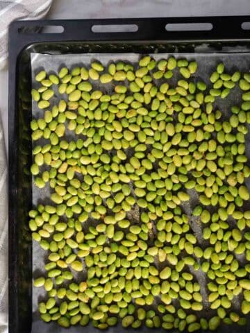 baking sheet with half-roasted edamame, to shake them before going to the oven for a second time.