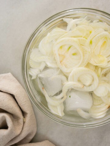 shaved fennel soaking in cold water with ice cubes.