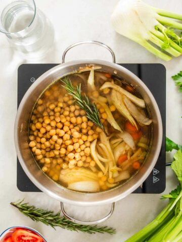 add cooked chickpeas, vegetable bouillon, water, and a Rosemary sprig.