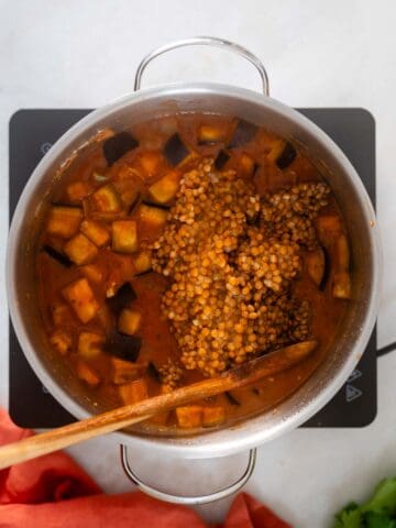 adding lentils into the pot.