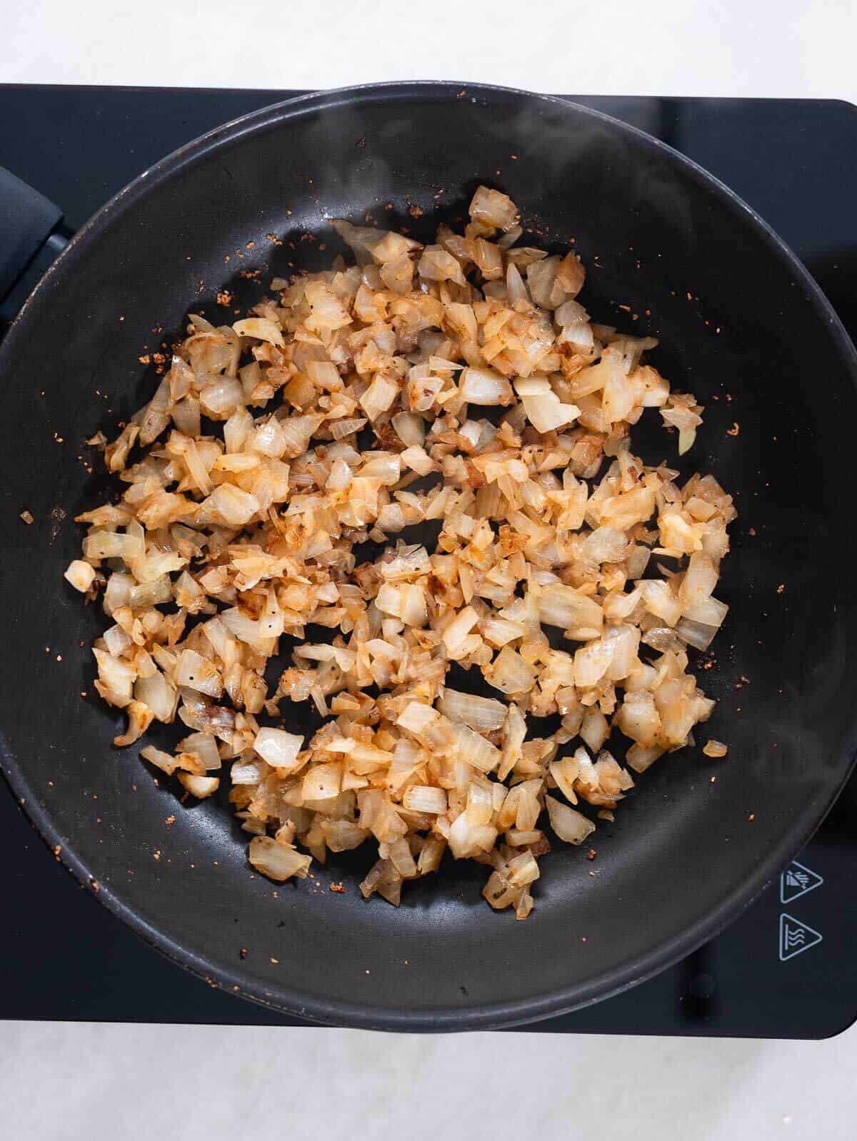 stir-frying onions in a skillet.