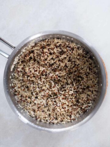 cooked and fluffed quinoa in a small saucepan.