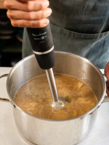 Blending the soup to achieve a smooth, creamy texture.