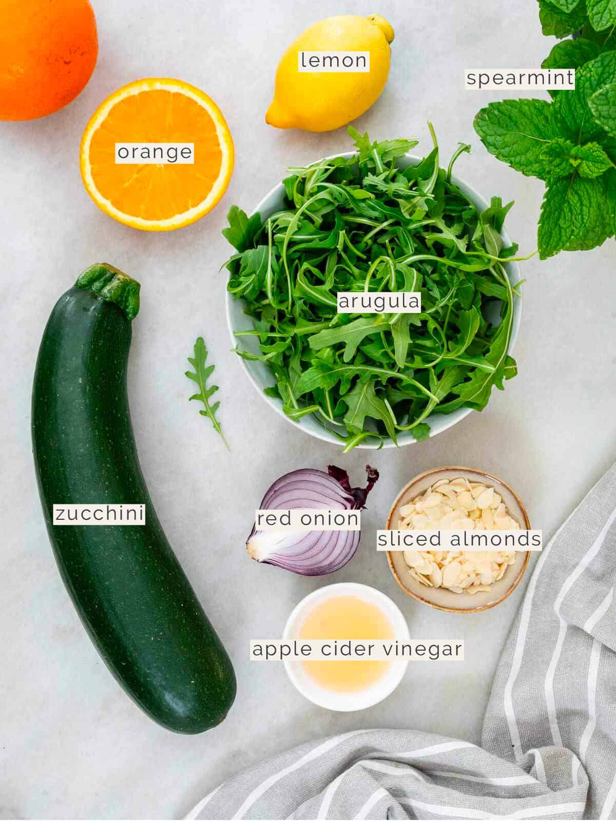 ingredients to make a marinated raw zucchini salad.