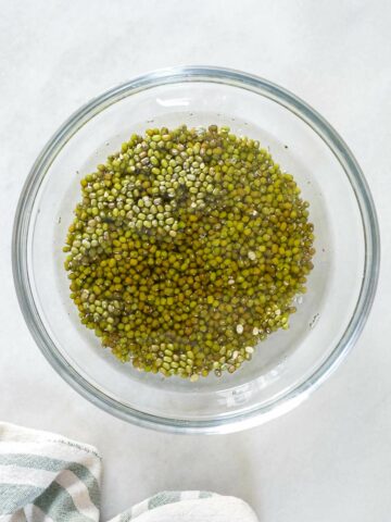soaking mung beans in a bowl with water.