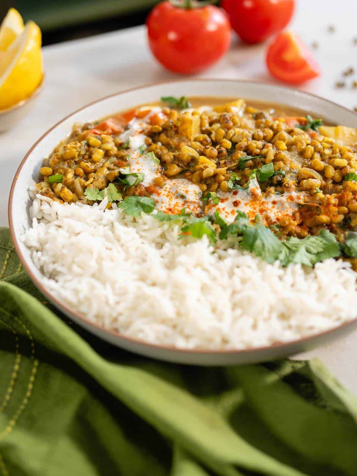 serving with chopped coriander, a swirl of coconut milk and cooked basmati rice.
