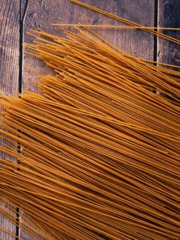 bran spaghetti spread on a wooden table.