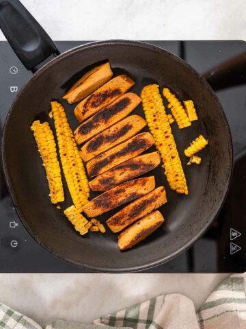 pan-fried seitan and corn strips in a skillet.