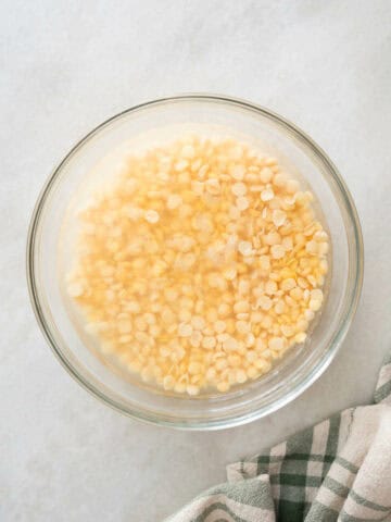 soaking yellow lentils in a bowl with water.