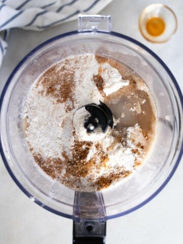 food processor with dry and wet ingredients.