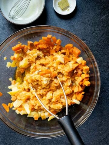 mashing cooked sweet potatoes and regular potatoes.