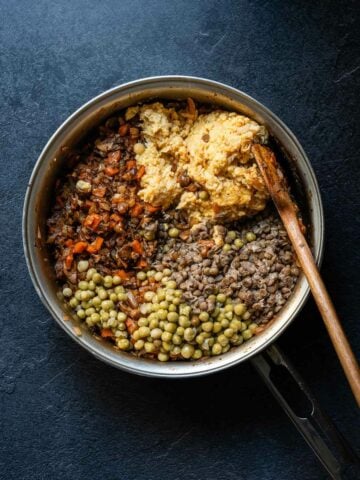 Cooked lentils and vegetables in a pot, ready to be layered for the shepherd's pie.